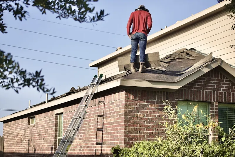 Professional roofer working on a residential roof in Caln Meeting House